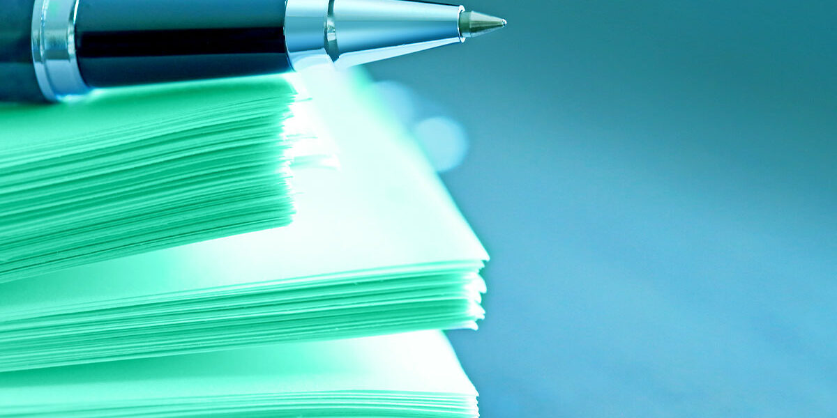 Pen on a stack of paper
