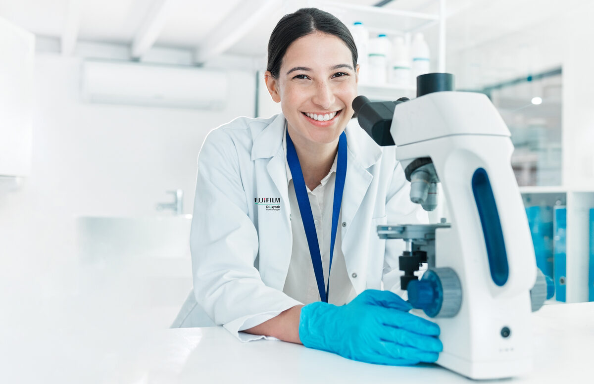scientist using a microscope in a lab