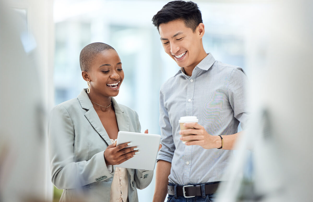 Smiling coworkers looking at a tablet