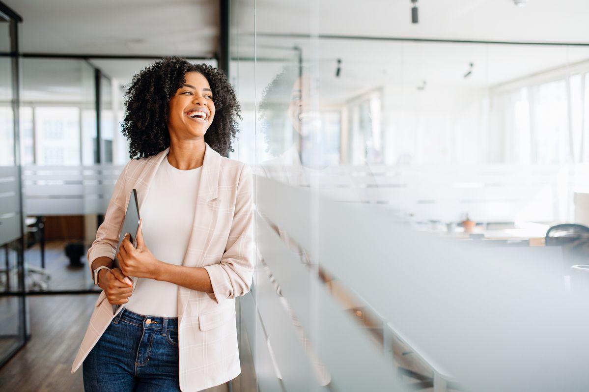 businesswoman standing in a modern office corridor