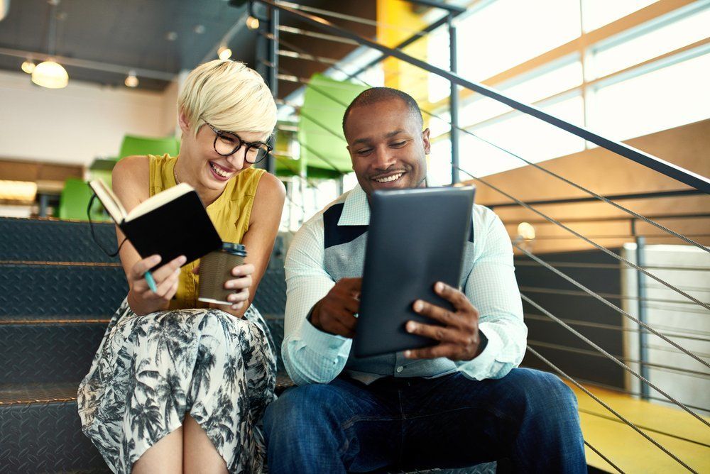 Coworkers reviewing information on a tablet