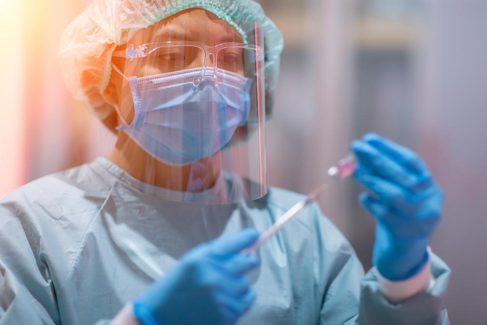 Scientist filling a syringe