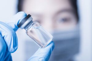 Woman holding a vial